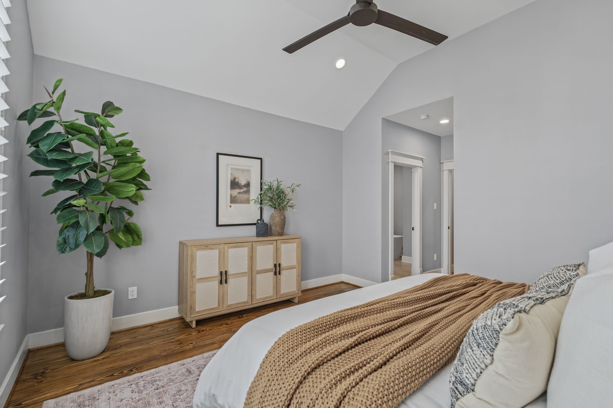 Natural light and private backyard views create a relaxing atmosphere in this second floor primary.