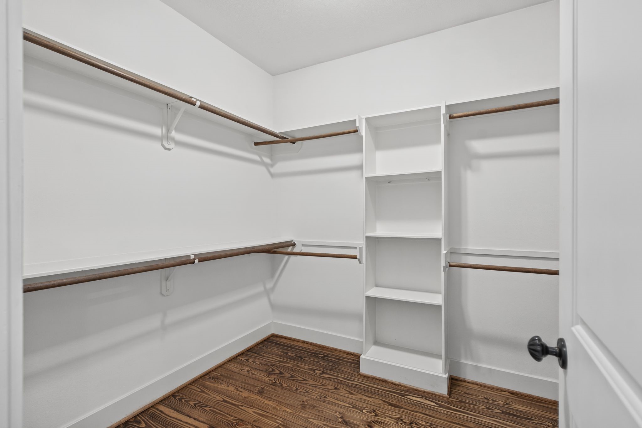 The generously sized primary closet offers ample room for wardrobe organization and storage.