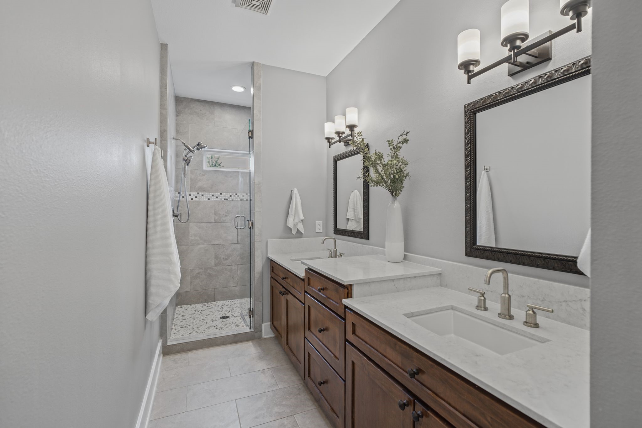 Light countertops complement warm wood cabinetry, offering a clean, inviting look with ample storage.