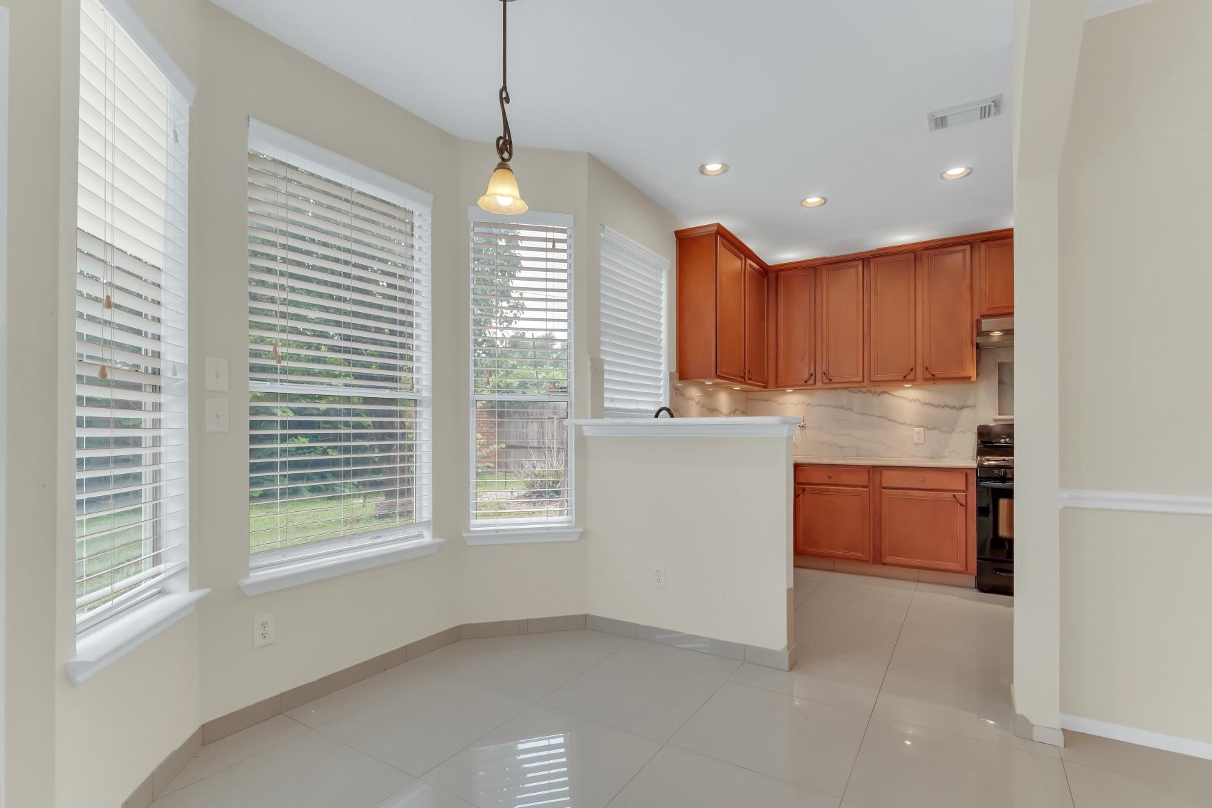 Breakfast area,  11x8, Tile flooring with the view of backyard.
