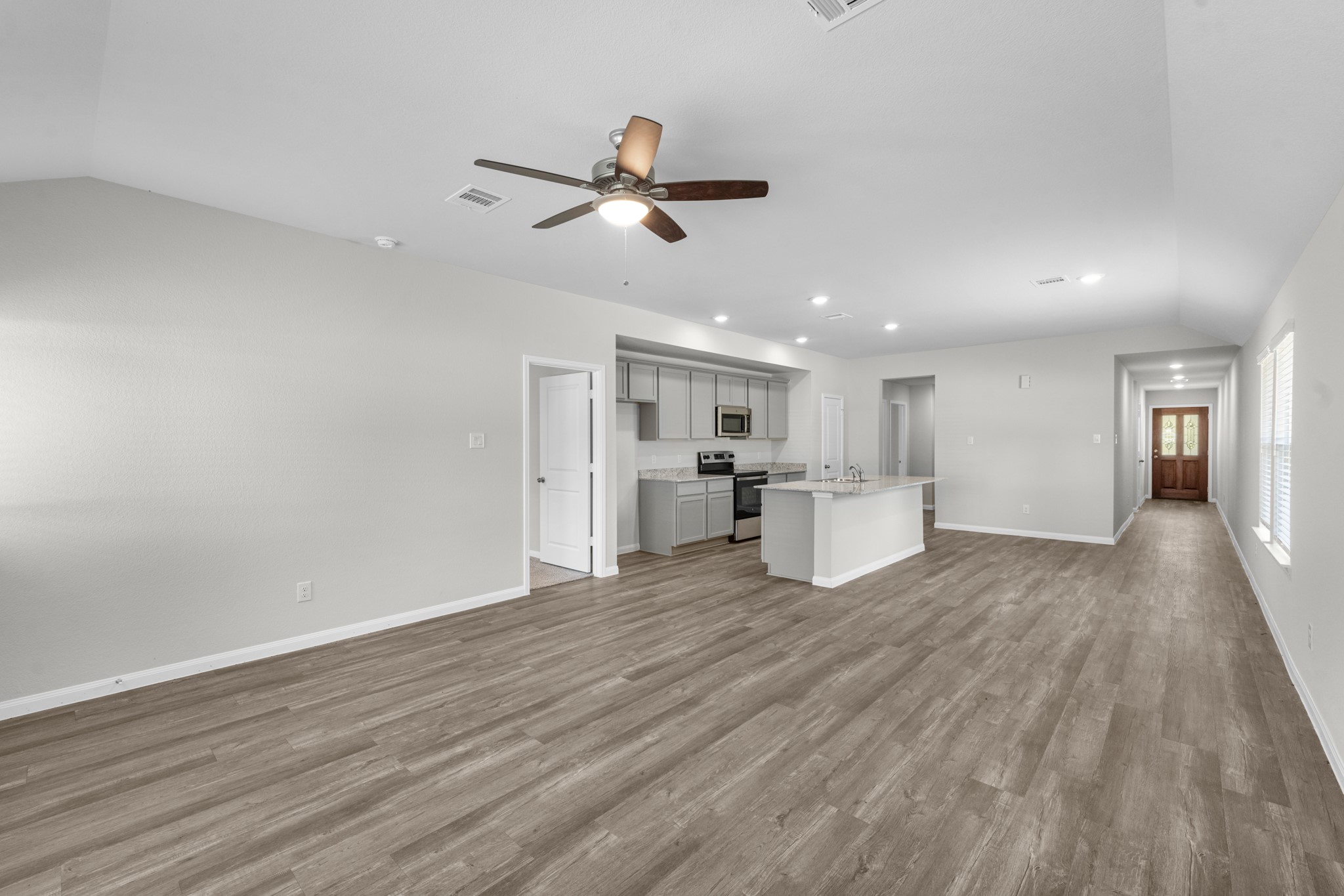 View of the entry and kitchen from the family room.