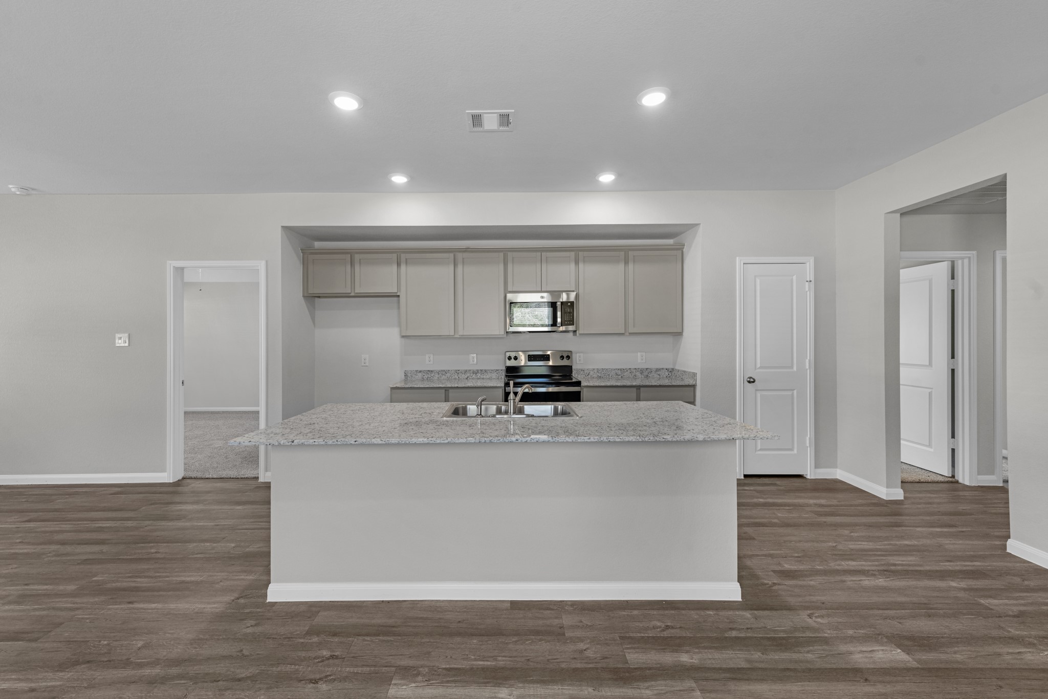 Additional view of the kitchen showing access to the pantry.