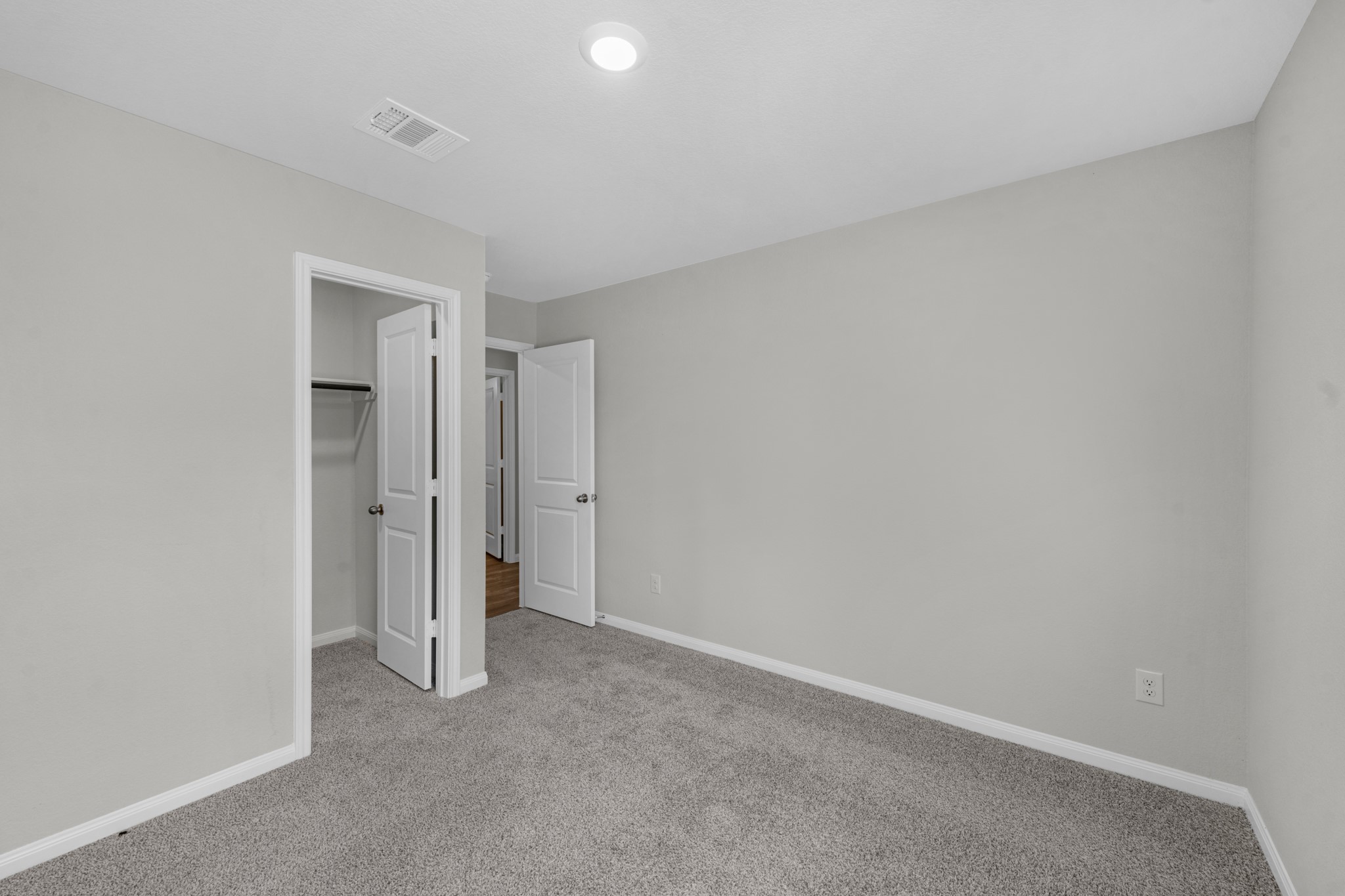 Additional view of guest bedroom #1 of 2 showing the walk in closet.