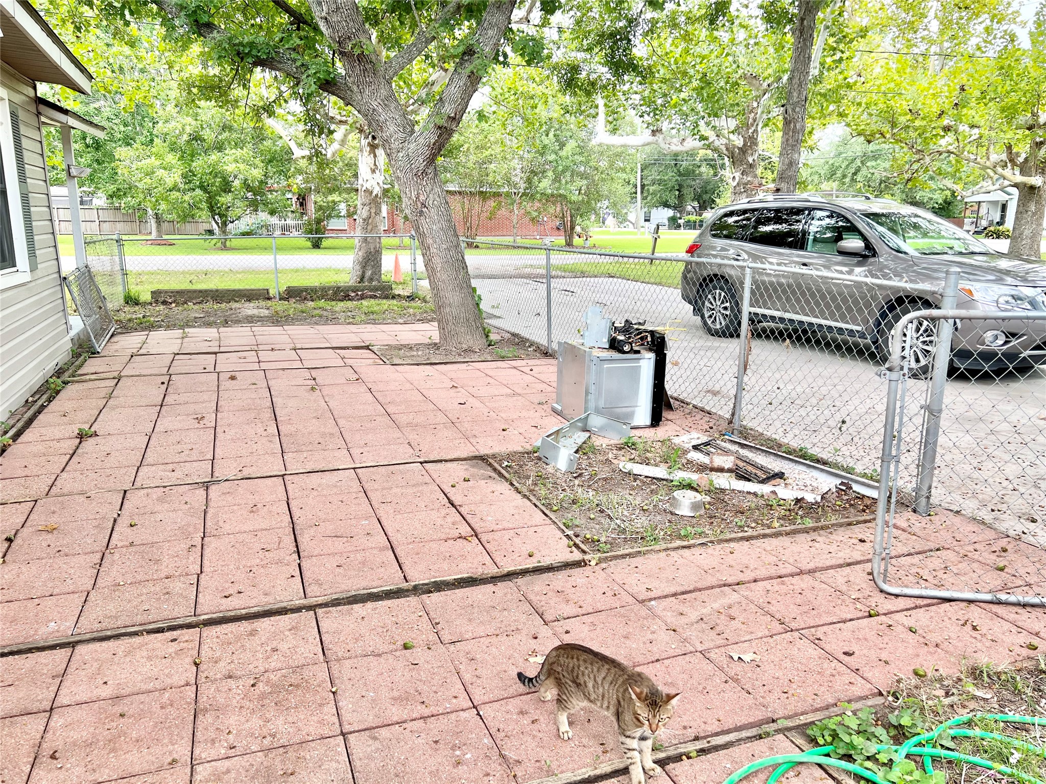Paved courtyard (which has since been cleaned up is separately fenced form the back yard which is also fenced.