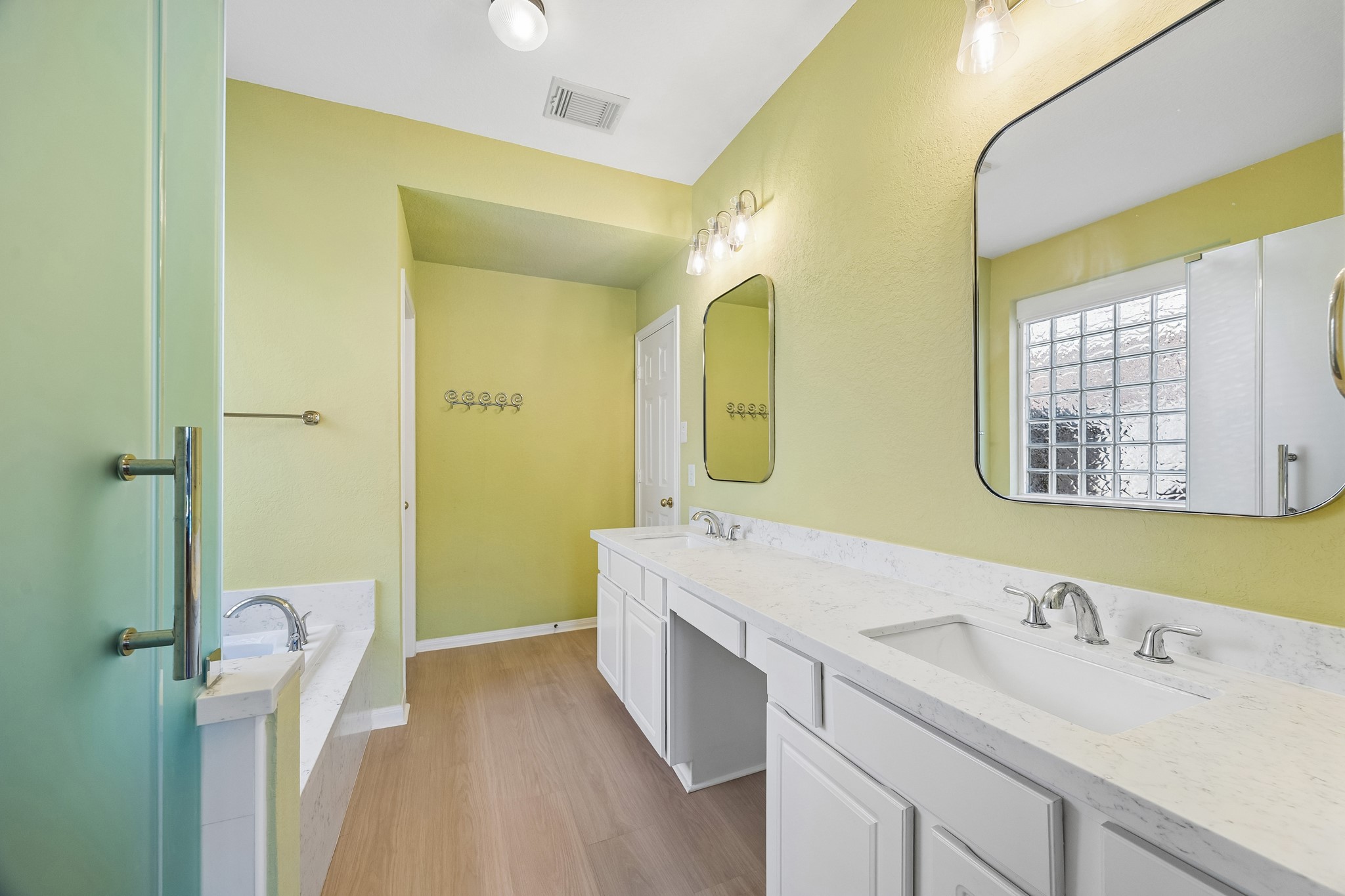 Fresh, cheerful and thoughtfully updated, the primary ensuite offers a bright place to start and end the day with a long dual sink vanity, Jacuzzi tub, separate shower and a private water closet.
