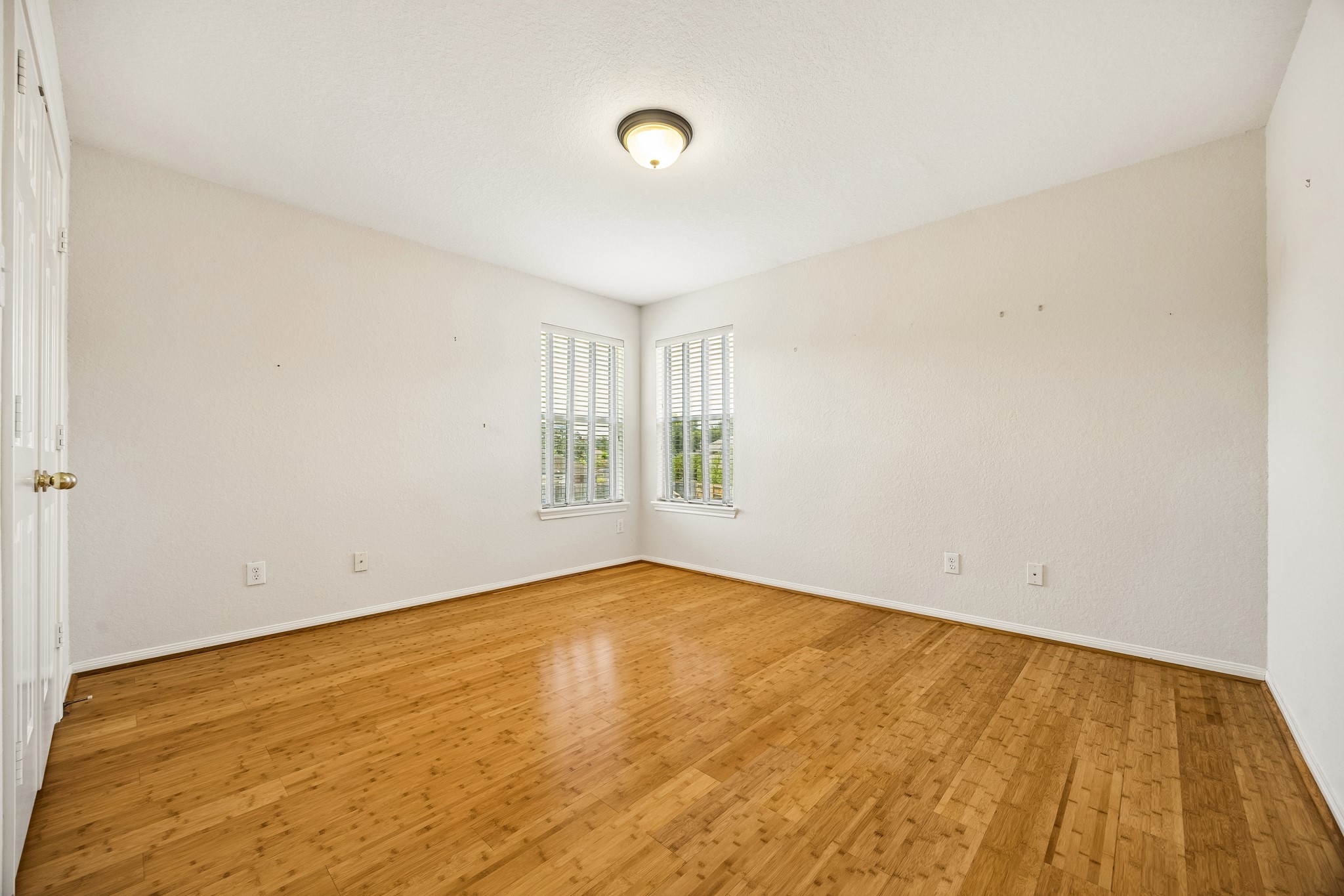 With three very spacious guest bedrooms, youll always have room for company. This inviting bedroom offers a fresh neutral color palette, bamboo flooring, a large closet and a full bathroom nearby, making it a comfortable retreat for family and overnight guests.