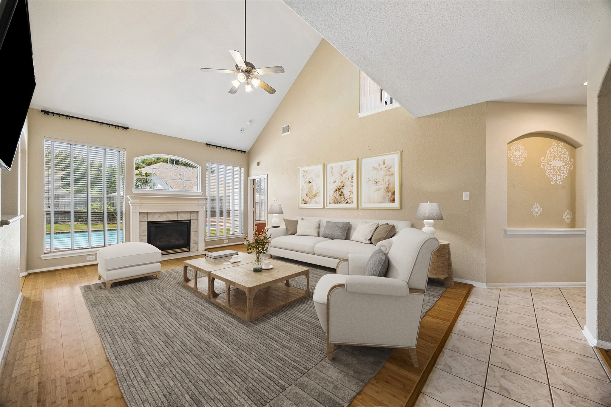 Kick back and enjoy the view. This light filled family room pairs a gas log fireplace with warm bamboo flooring, a soaring ceiling and pool views that make everyday downtime feel a little more relaxing.