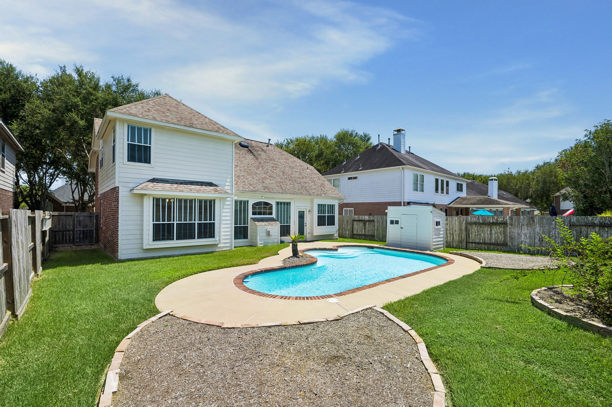 Summer days were made for this backyard, where an oversized pool ranges from 3 to 8 feet deep and still leaves plenty of grassy space for yard games, play and pets. A thornless blackberry bush adds a sweet touch, producing handfuls of fresh blackberries each early summer.