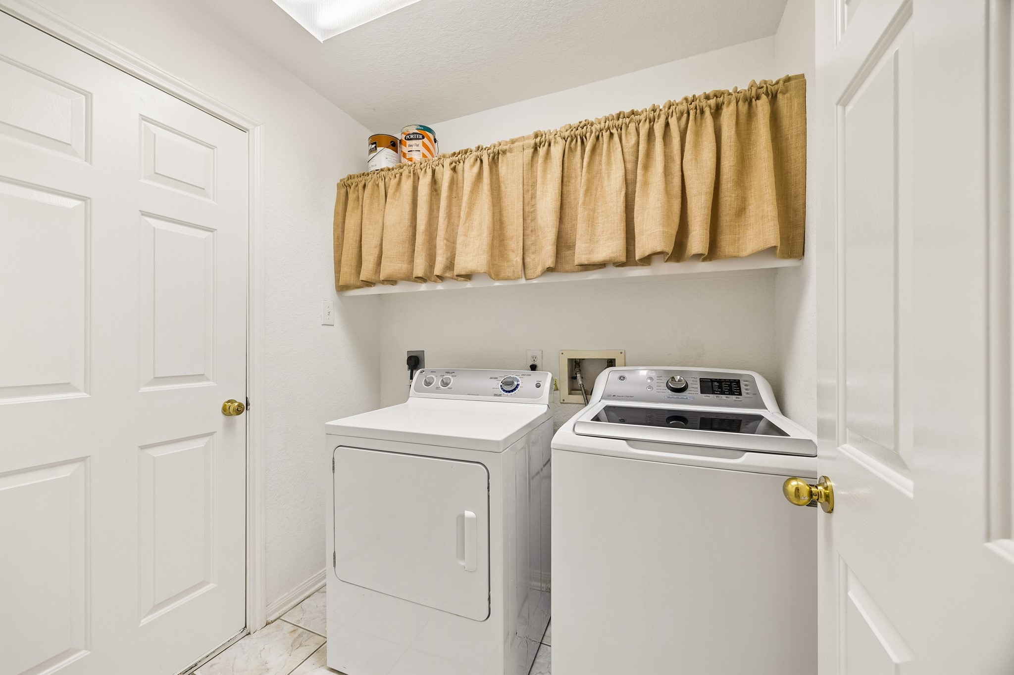Crisp, clean and conveniently located near the kitchen, the utility room keeps laundry day simple with washer and electric dryer connections, and open shelving for detergents, baskets and everyday essentials.