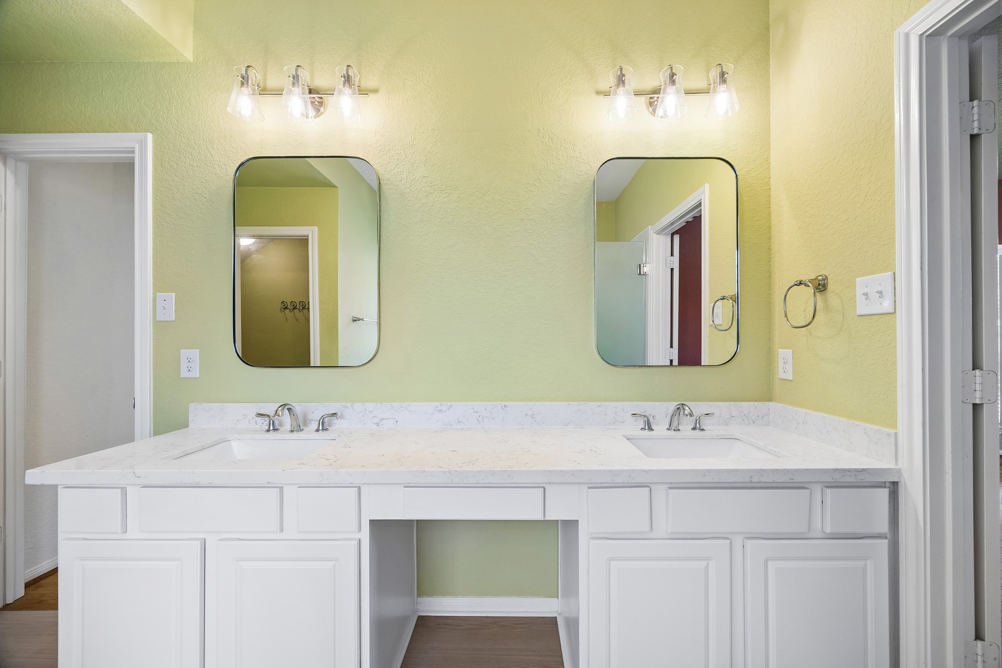 The updated vanity in the primary ensuite brings style and function together with sleek under mount sinks, framed mirrors, stylish lighting and plenty of counter space and storage.