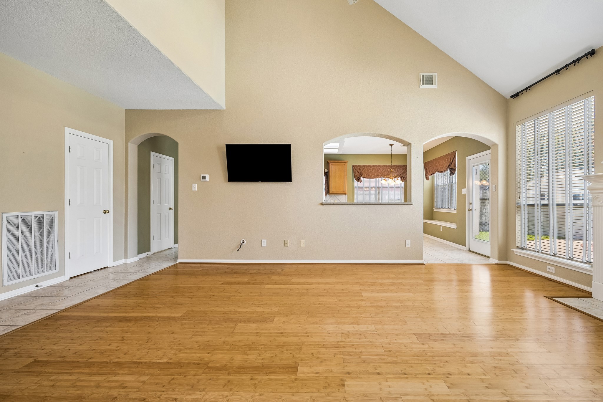 Open to the kitchen and breakfast area, this roomy family room keeps everyone connected while bamboo flooring, a vaulted ceiling and oversized windows create a bright, comfortable place to gather and relax.