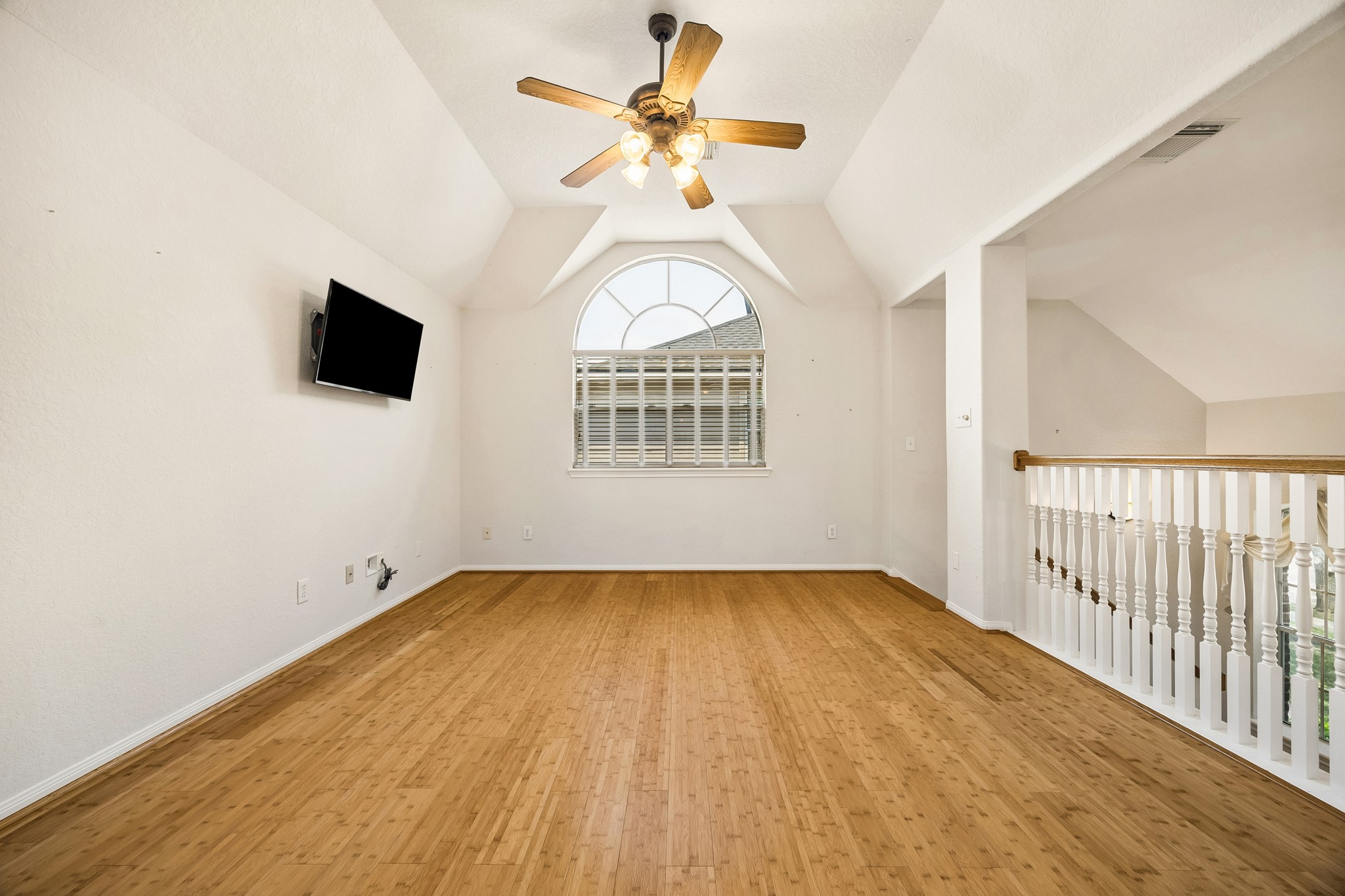 Make this upstairs game room your favorite place to play, relax and recharge, with warm bamboo flooring, a vaulted ceiling and plenty of room for game tables, movie nights or your own fun setup.