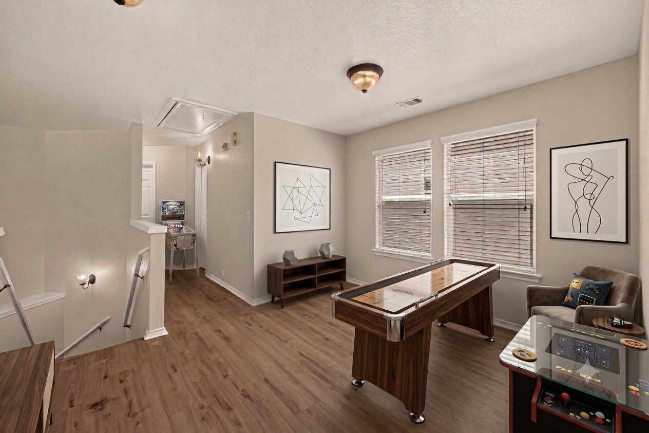 This beautifully crafted home features a virtually staged game room, perfect for entertainment and relaxation, set in a charming, lush neighborhood.