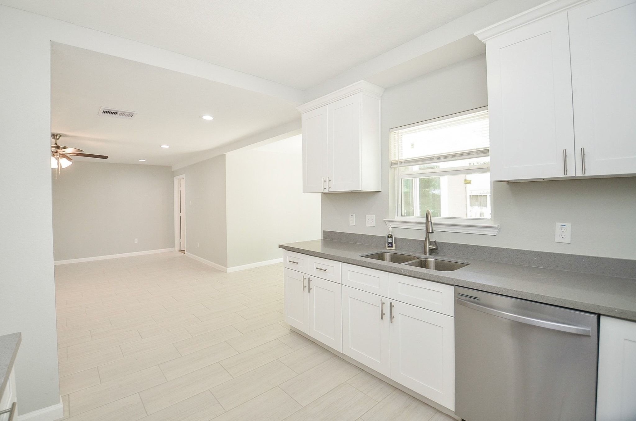 A large window above the huge double sink allows natural light to flood the space. Easy access to the living and dining space.