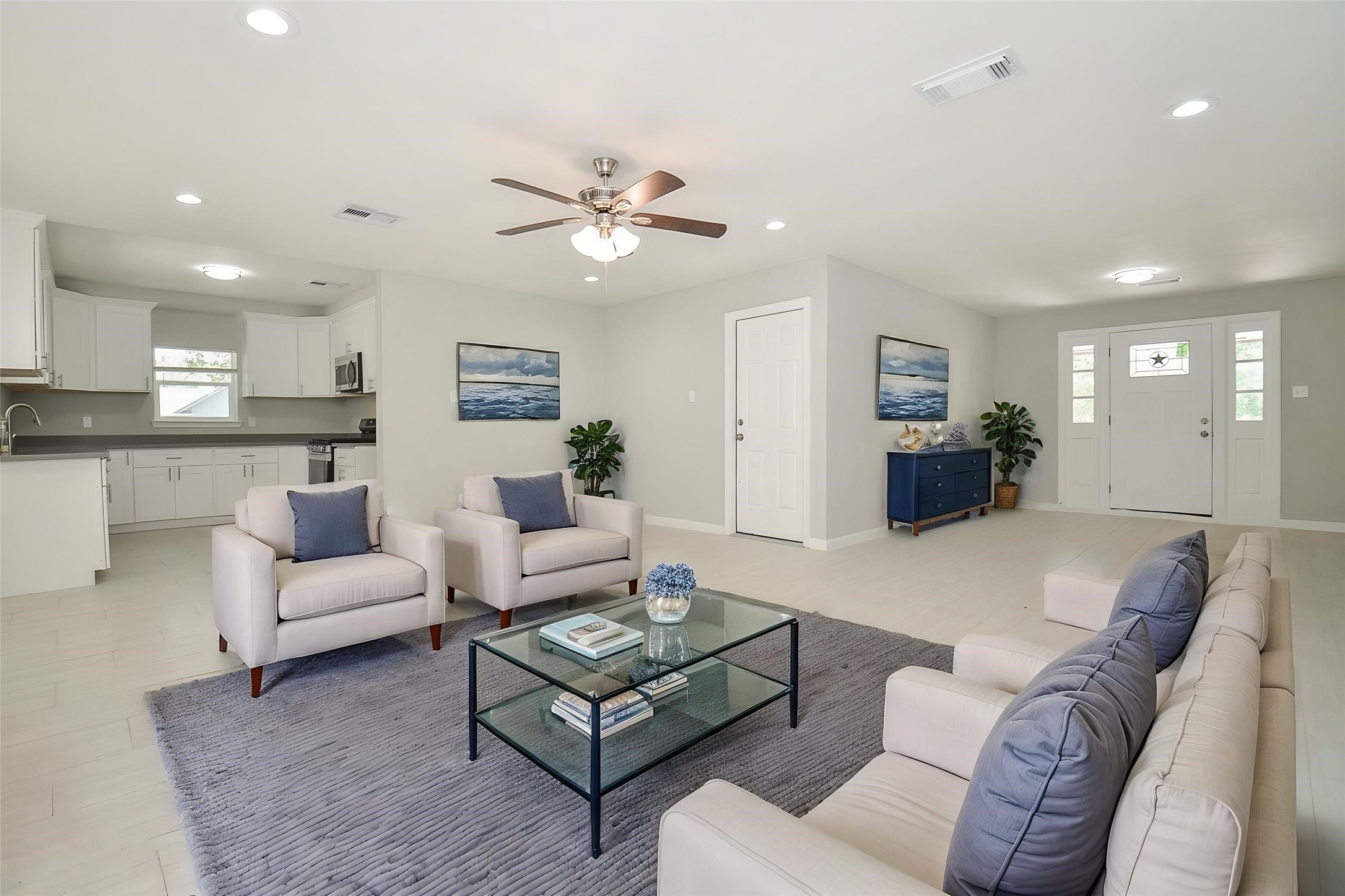 Walk into an open floor plan that seamlessly connects the living, kitchen, and dining space.