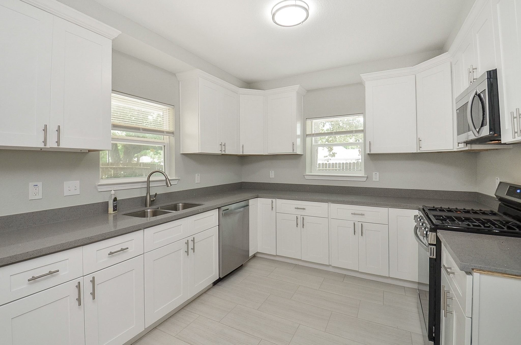 The crisp, white cabinetry offers ample storage space and the spacious counter tops allow meal preparation to be easy and convenient.
