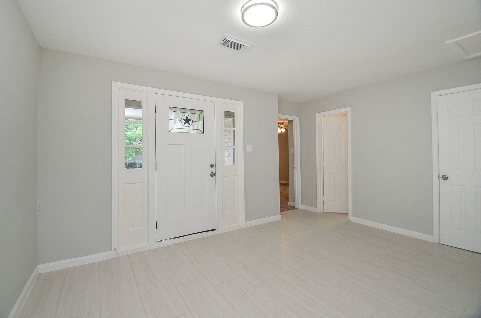 This well lit entryway gives a modern touch to the home.