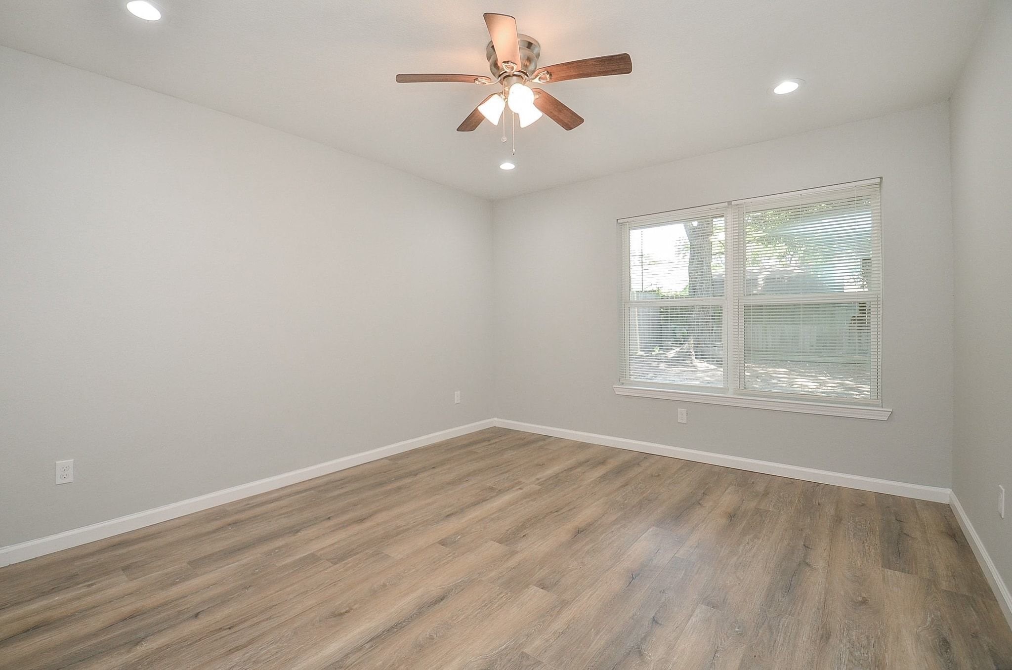 The huge window gives this next bedroom the perfect touch to brighten up the room. This room is also equipped with a ceiling fan for comfortable temperatures year round