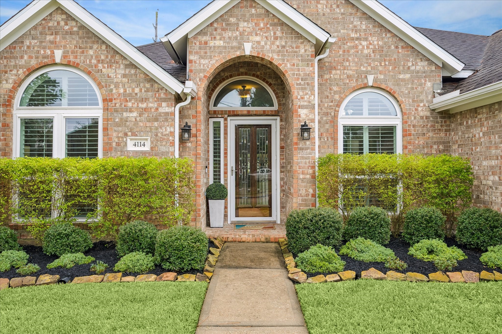 A beautiful welcome home! The inviting front entrance offers timeless curb appeal and a glimpse of the elegance and attention to detail that await inside.