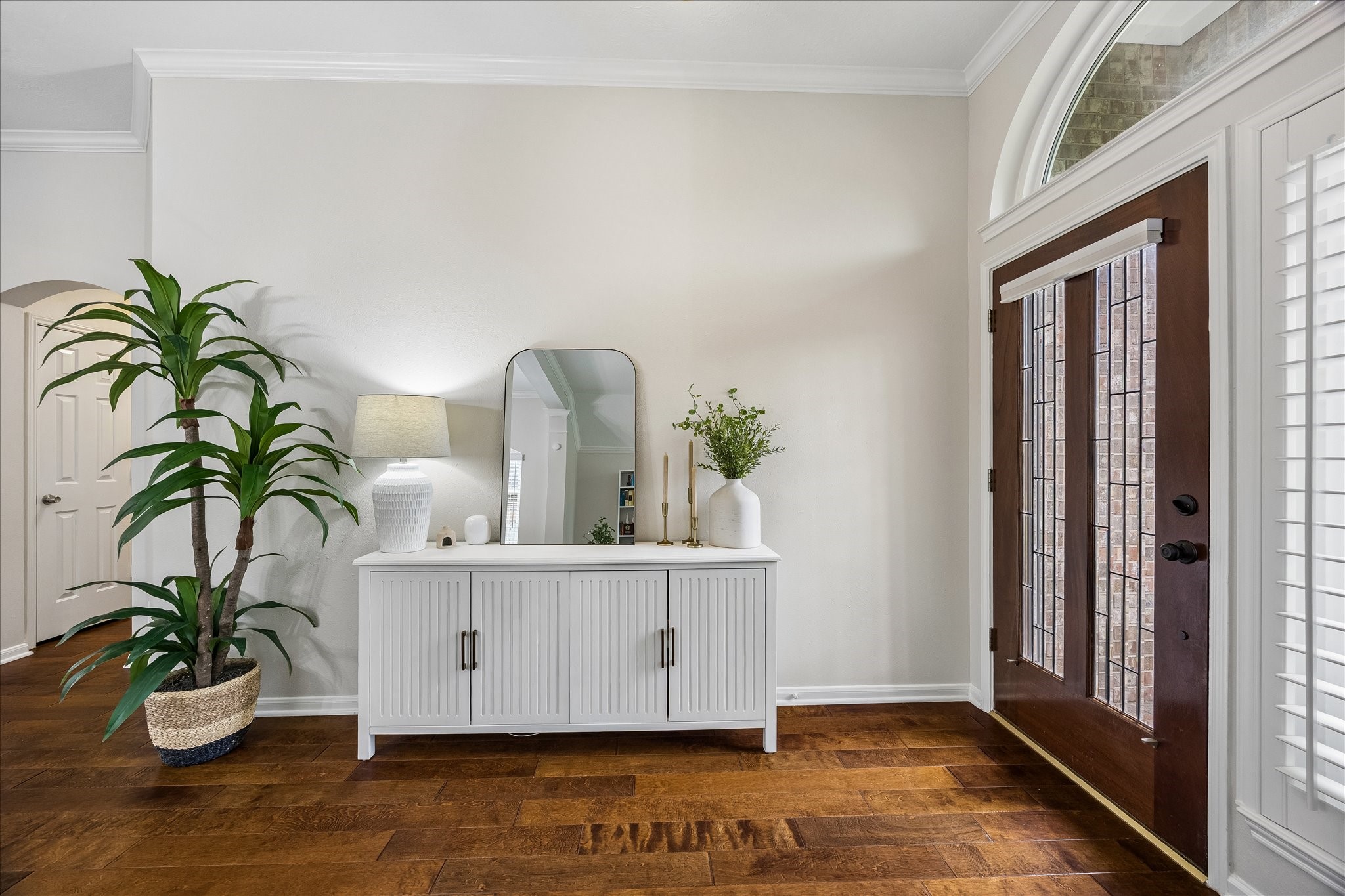 A beautiful blend of warmth and sophistication! The spacious foyer offers a graceful welcome with rich wood flooring, elegant double entry doors, and plenty of room for a stylish entry console.