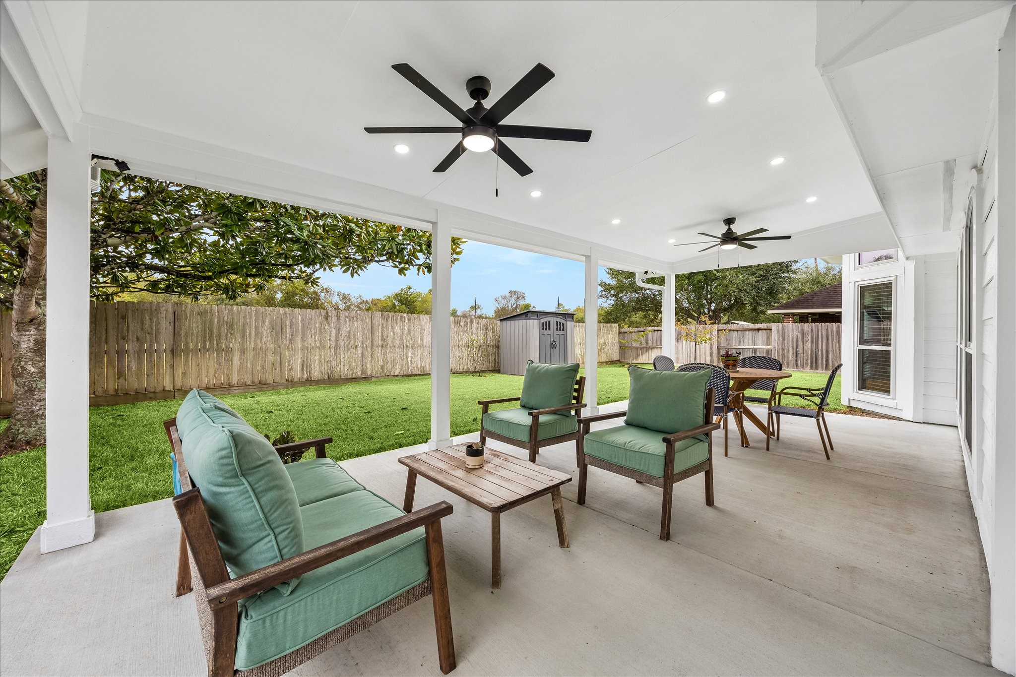 Outdoor living at its finest! This incredible extended covered patio features ceiling fans, recessed lighting, and upgraded electricalcreating the perfect setting for morning coffee, weekend gatherings, or relaxing evenings overlooking the beautifully landscaped backyard with no rear neighbors!