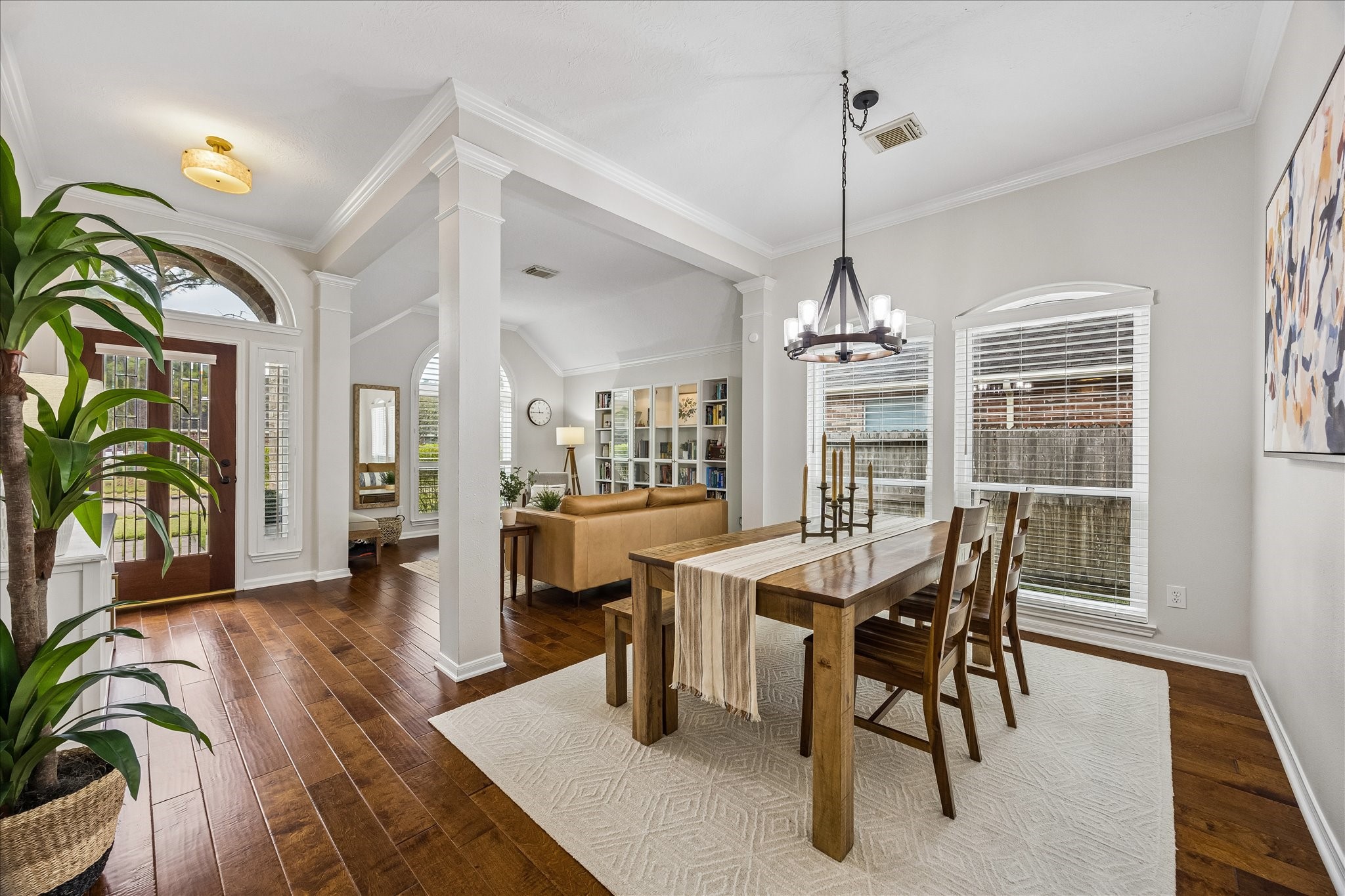 An unforgettable first impression! Soaring ceilings, elegant architectural details, rich wood flooring, and abundant natural light create an inviting space that feels straight out of a designer showcase.