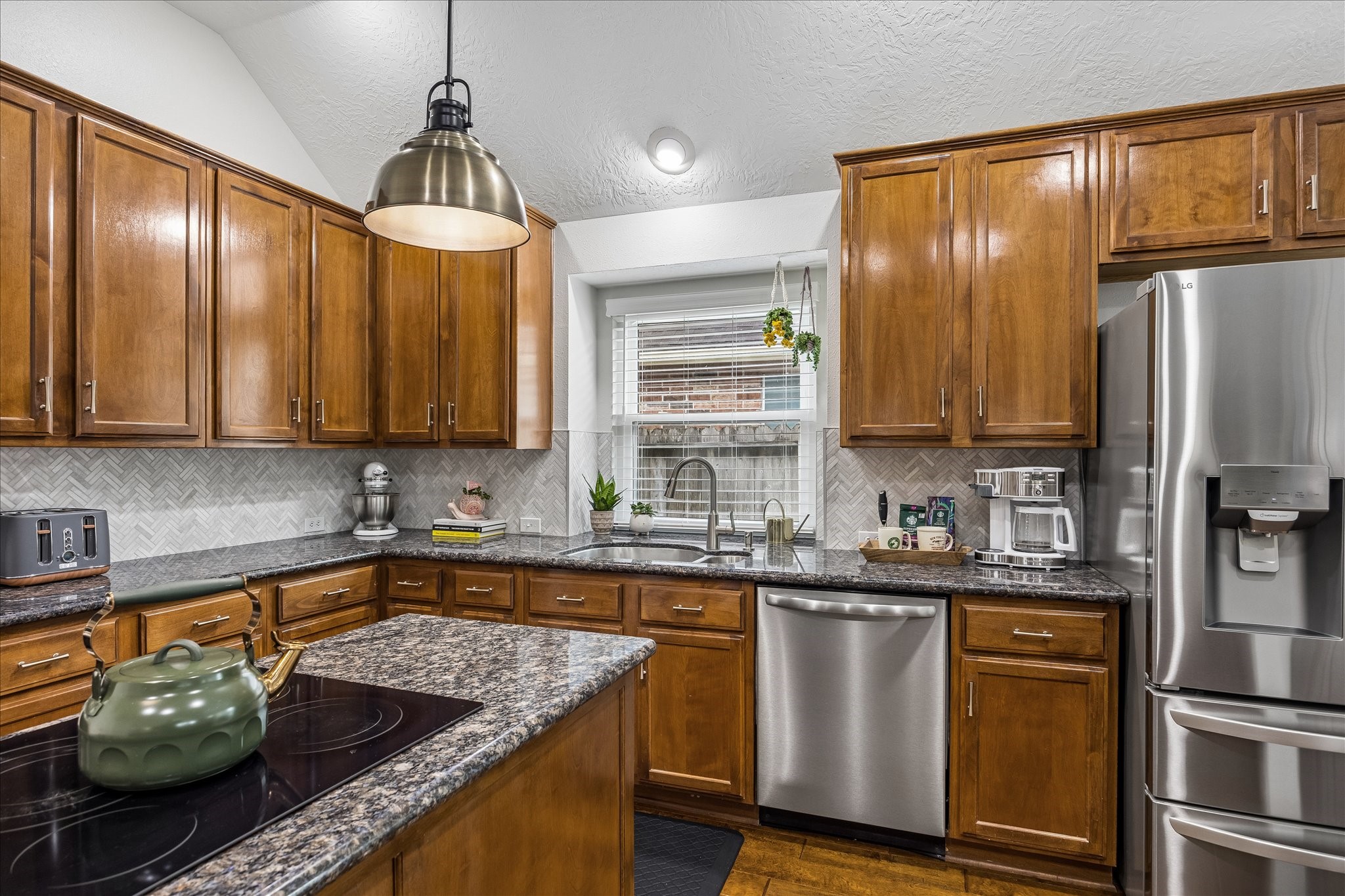 Designed with the home chef in mind! The spacious center island features a built-in cooktop, offering generous workspace and an efficient layout that makes everything from everyday meal preparation to hosting gatherings a breeze.