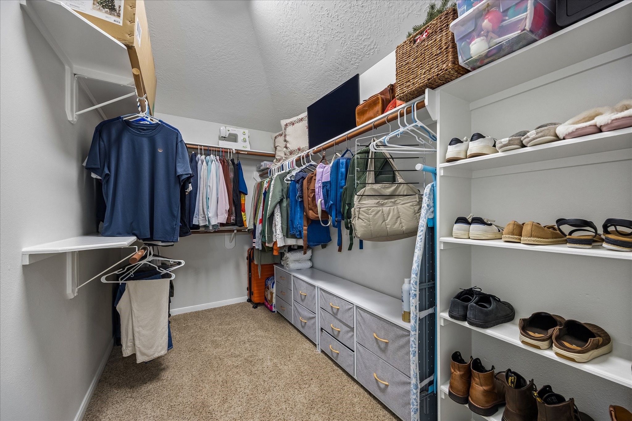 A place for everything! This generously sized primary walk-in closet offers abundant hanging space, shelving, and storage to keep your wardrobe beautifully organized and easily accessible.