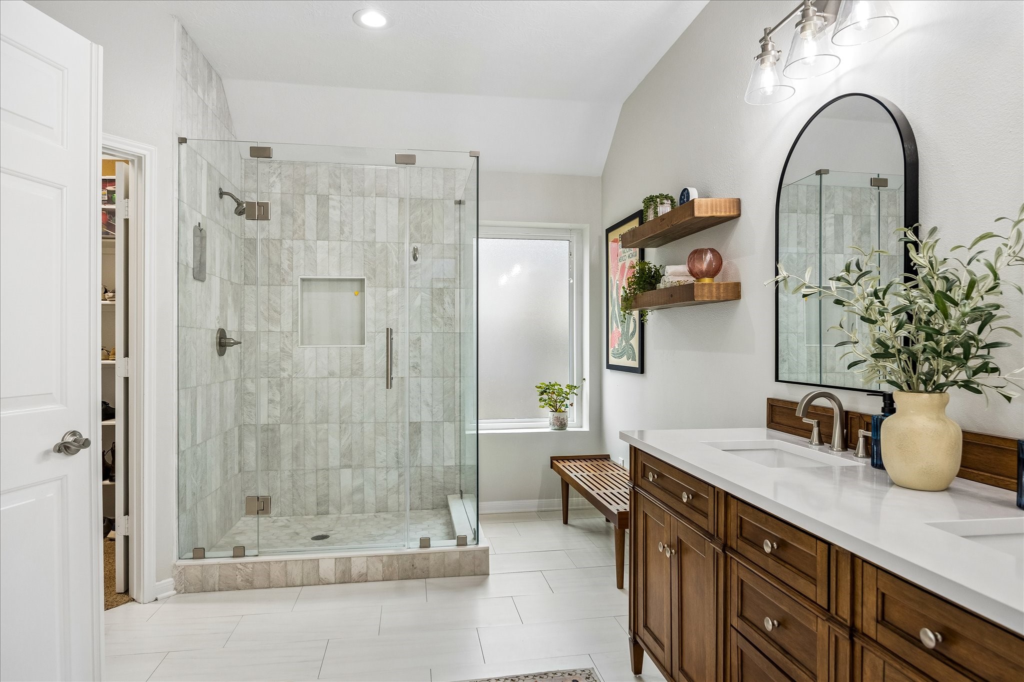 Your own private spa-inspired retreat! Beautifully remodeled in 2024, this stunning primary bath showcases an oversized glass-enclosed shower, elegant tilework, quartz countertops, and stylish new vanities. Every detail feels thoughtfully designed!
