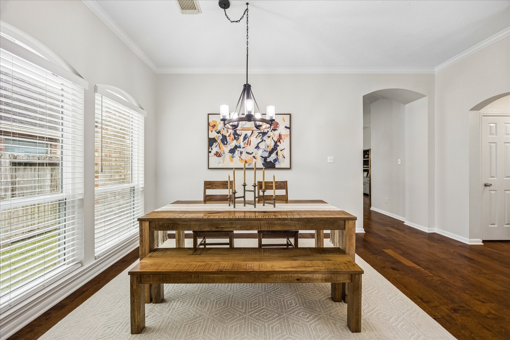 Host memorable dinners in this elegant formal dining room! A stylish statement chandelier, beautiful natural light, and generous space for gathering create the perfect setting for everything from intimate dinners to holiday celebrations.