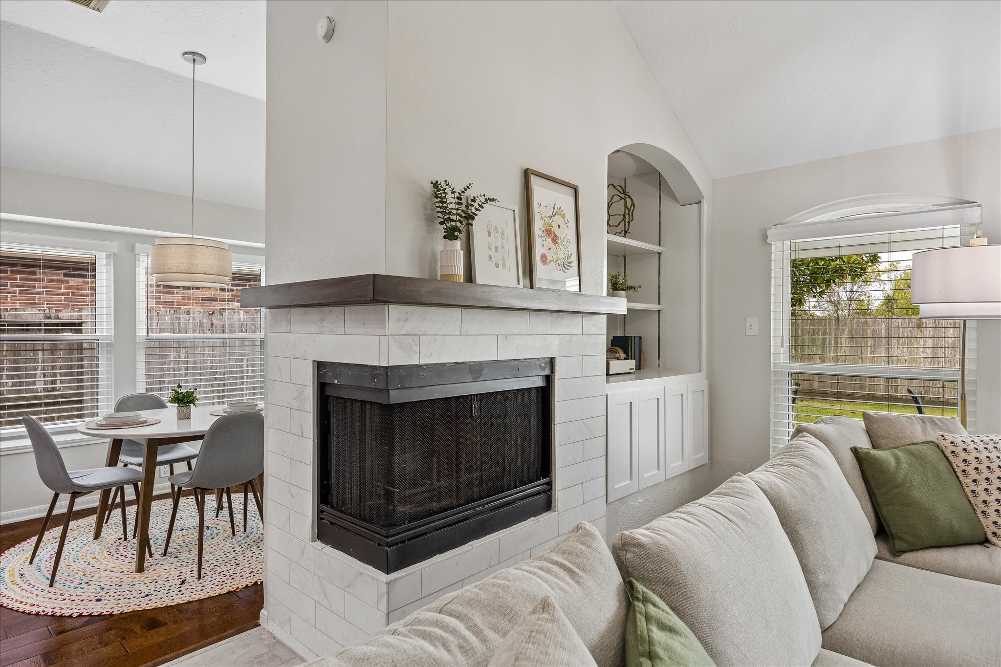 A stunning architectural focal point! Thoughtfully updated in 2024, this distinctive fireplace features a unique wraparound design that adds character and warmth to the living space. A beautiful statement piece that sets this home apart!
