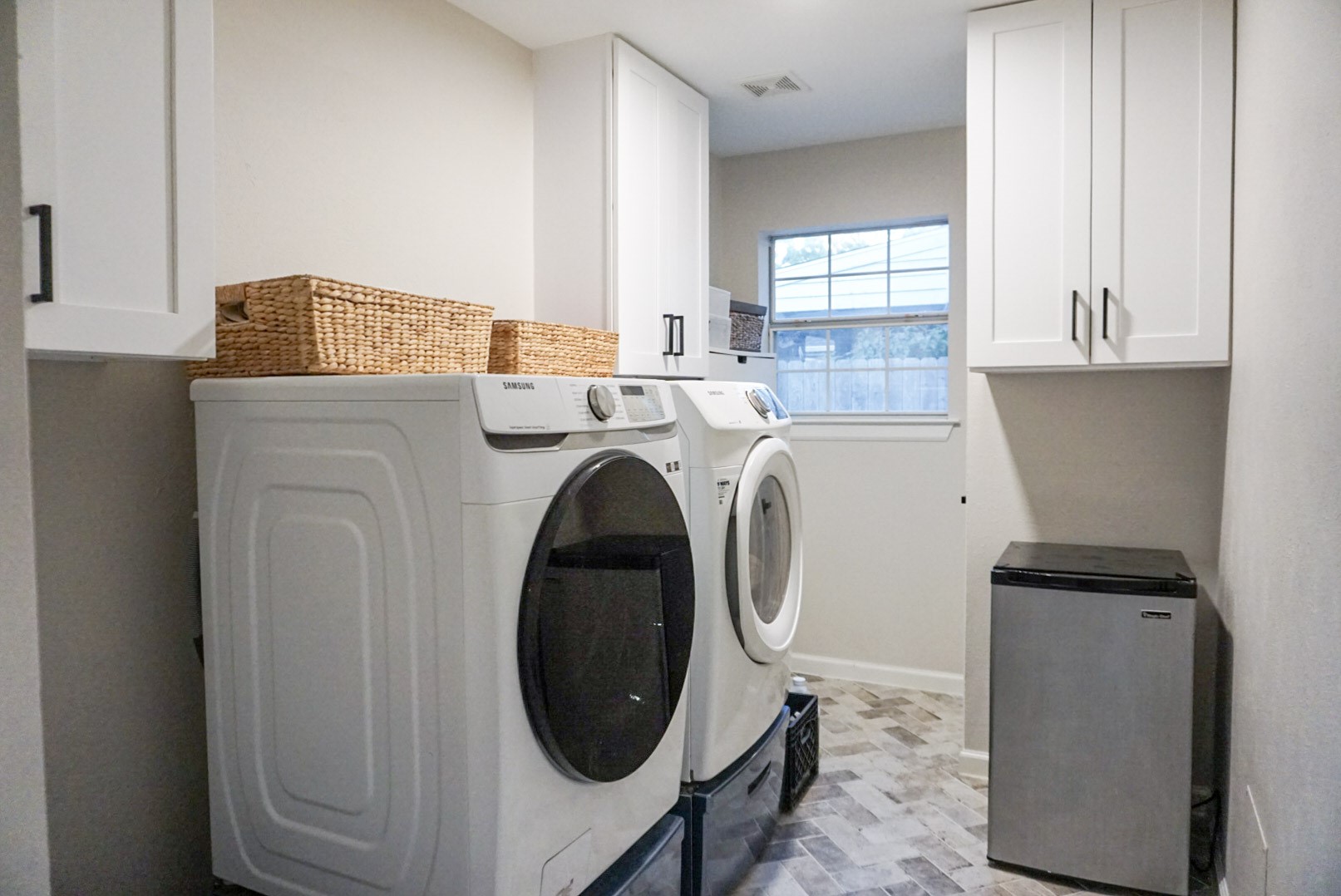 Laundry/Utility Room in house, across from dining/next to back door; Built in cabinetry
