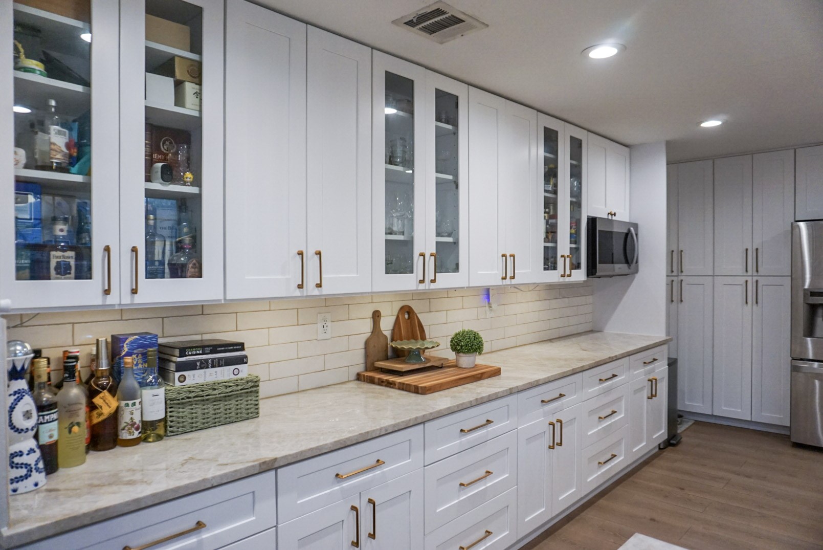 Another angle of kitchen showing beautiful designed cabinetry, spacious counters