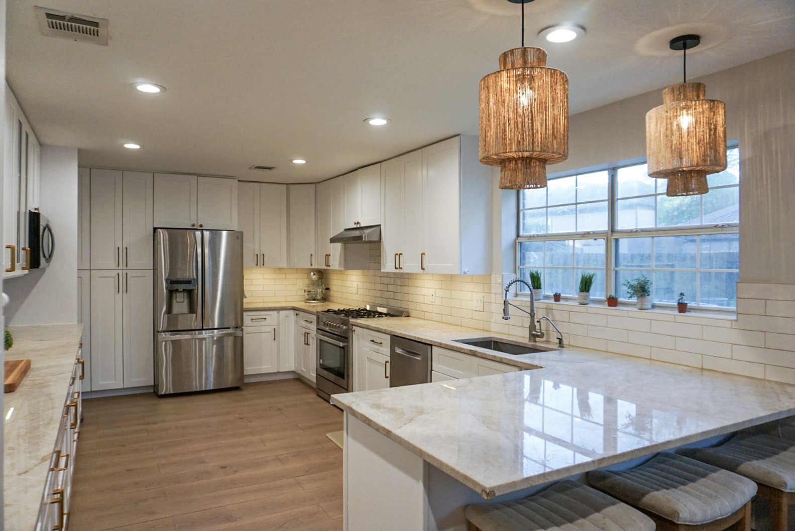 Taj Mahal Quartize countertops, custom cabinetry, rattan pendant lights, LED lights Taj Mahal Quartize countertops, custom cabinetry, rattan pendant lights, LED lights