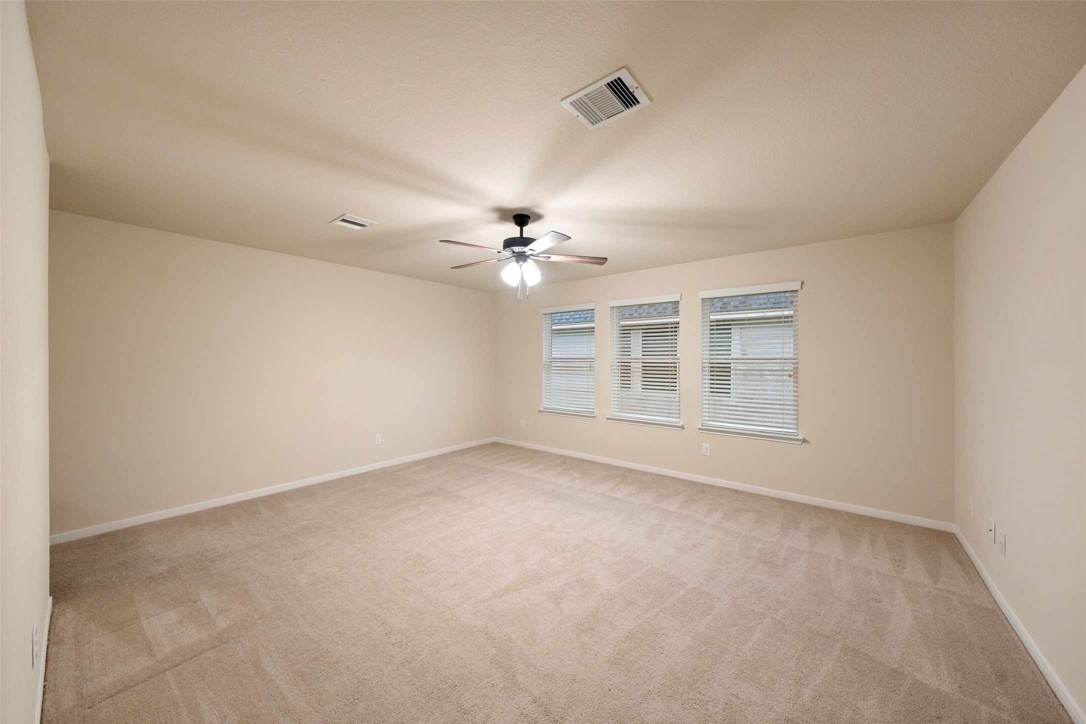 To the left of the stairs, sits an inviting game room with plenty of natural light.