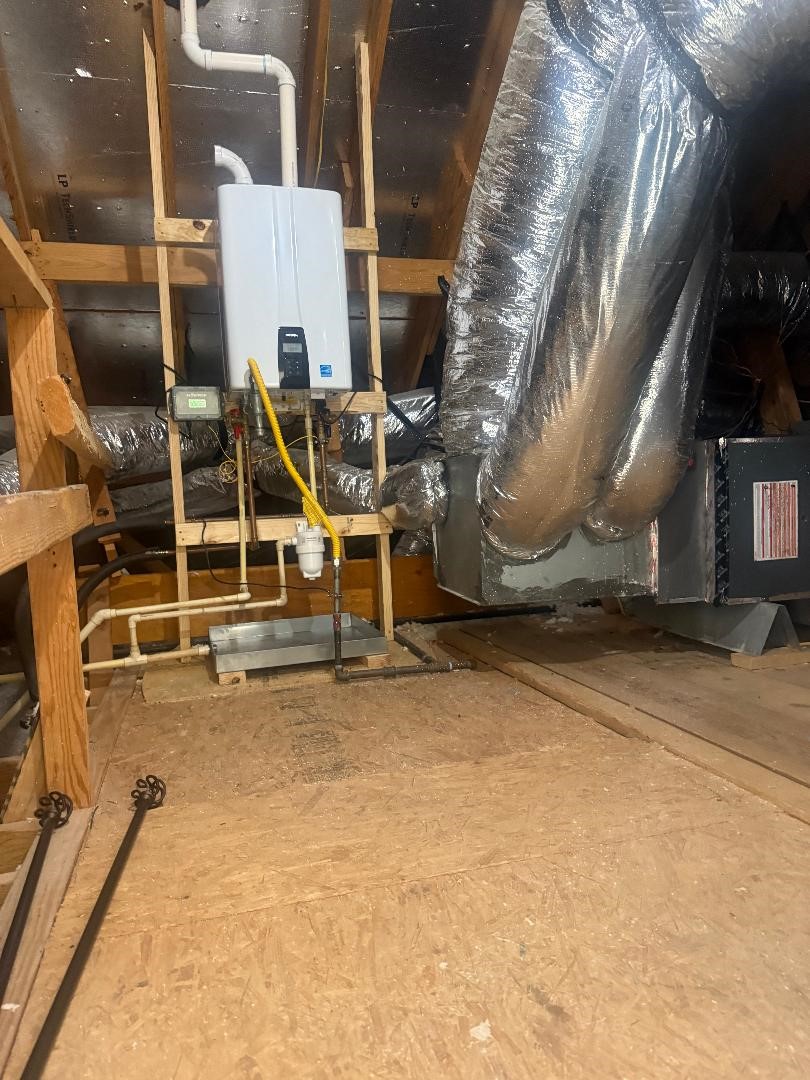 A secondary attic off the game room has also been outfitted as a walk-in and houses a tankless water heater.