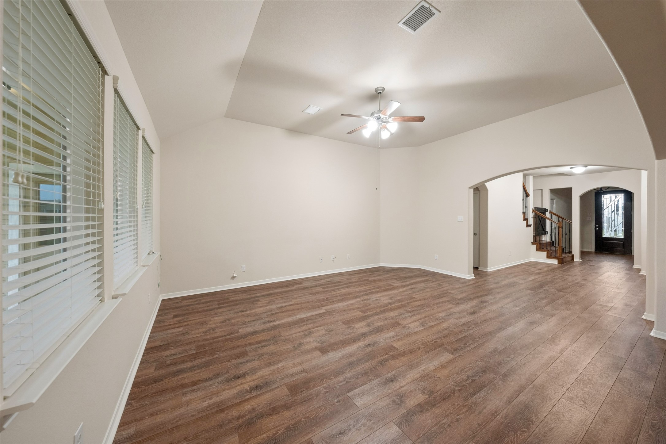 Spacious living area featuring a single sloped ceiling and plenty of windows allowing natural light in. Spacious living area featuring a single sloped ceiling and plenty of windows allowing natural light in.