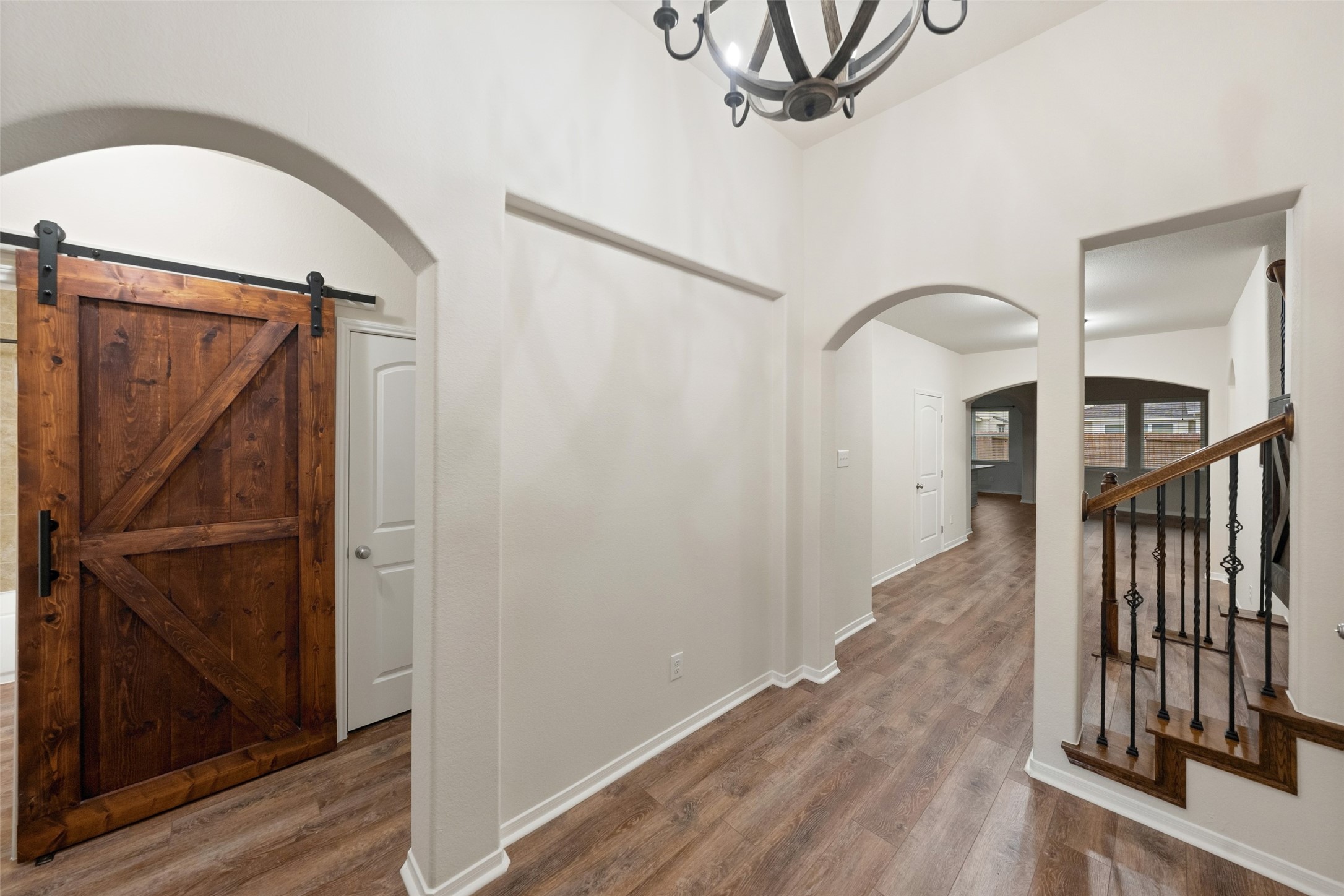 Another view of the foyer showcases the stairs and architectural design that opens up to the living and kitchen. Another view of the foyer showcases the stairs and architectural design that opens up to the living and kitchen.