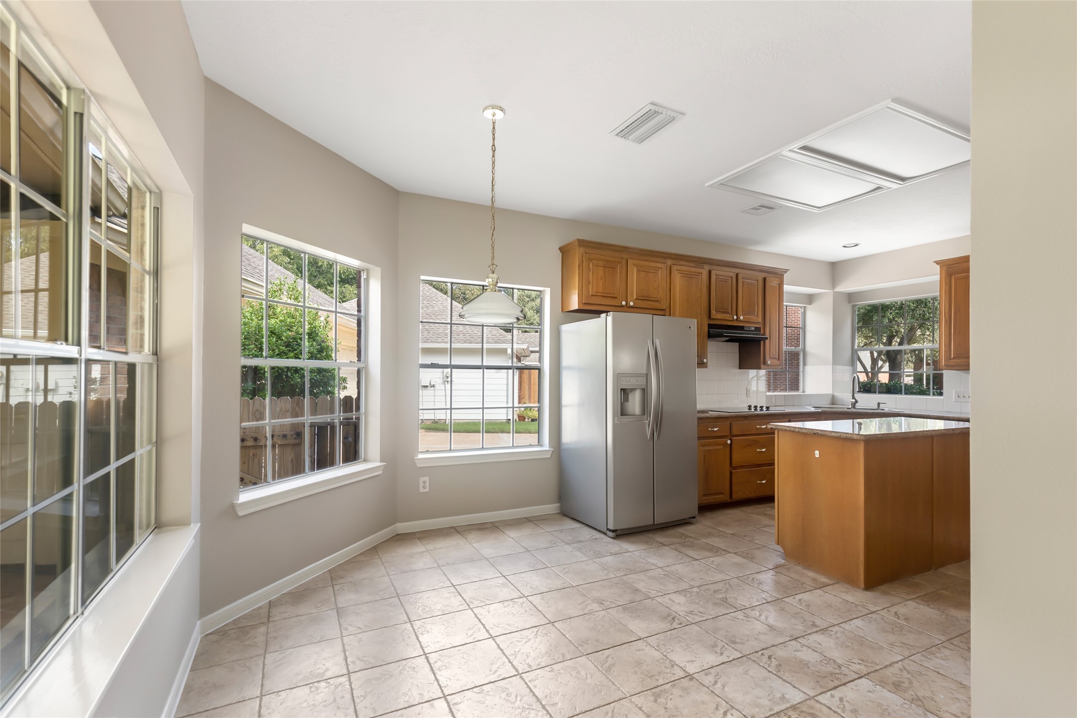 Breakfast nook with large windows overlooking the backyard