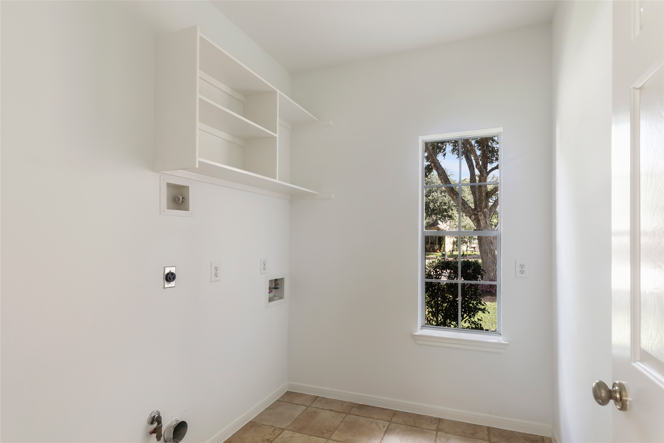 Indoor Laundry by kitchen that has plentry of room for a freezer or additonal refrigerator