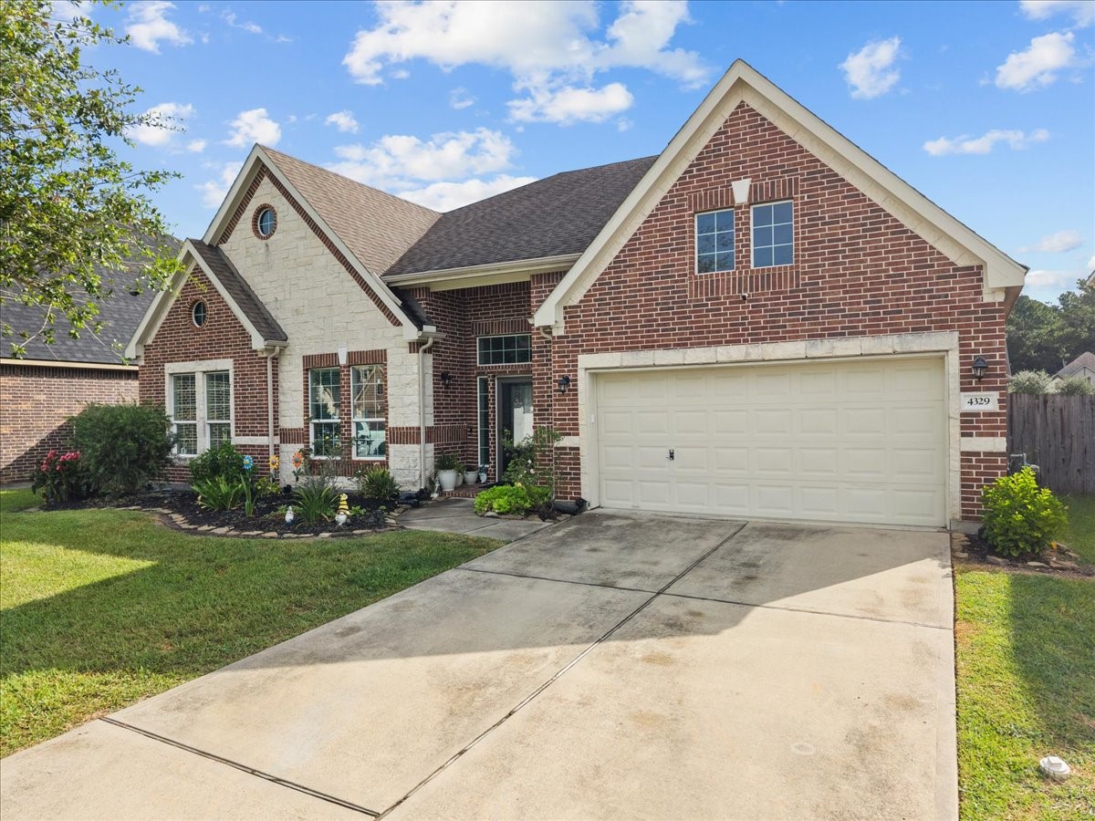 Classic brick and stone curb appeal with an attached 3 car garage and wide driveway. Classic brick and stone curb appeal with an attached 3 car garage and wide driveway.