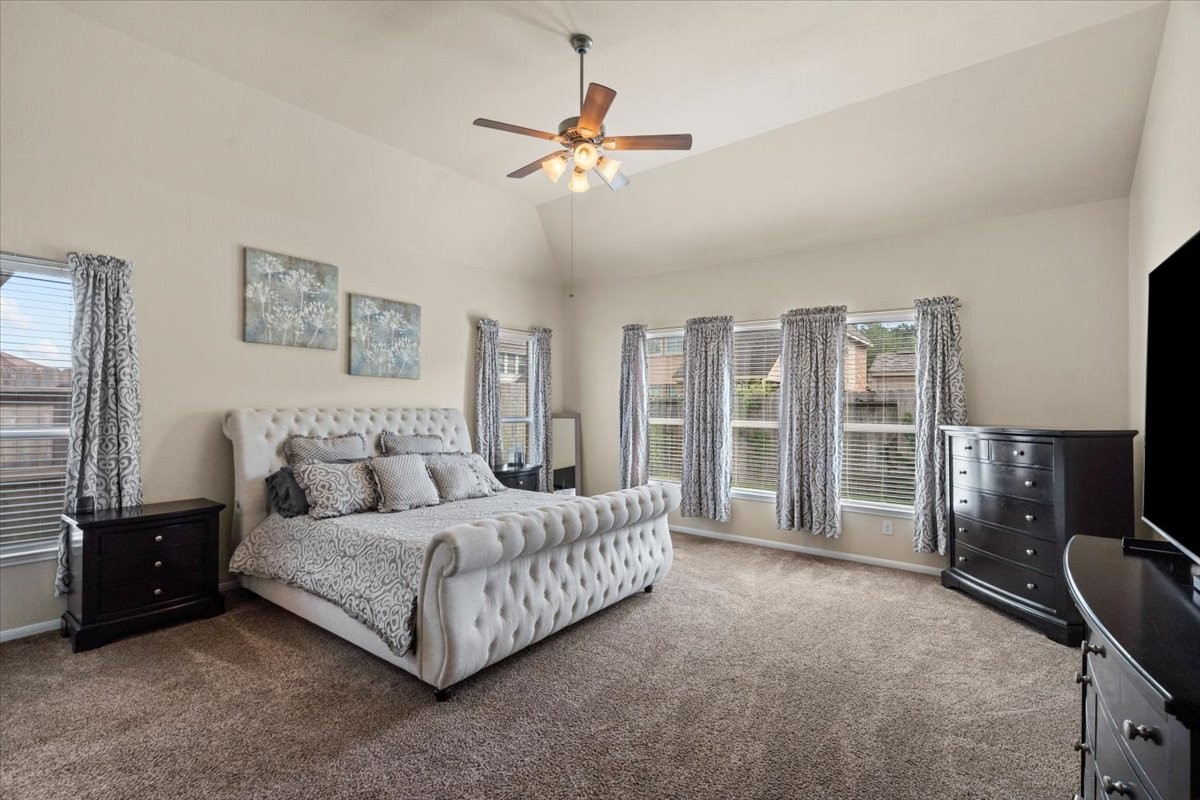 Primary bedroom with room for a sitting area and large windows.