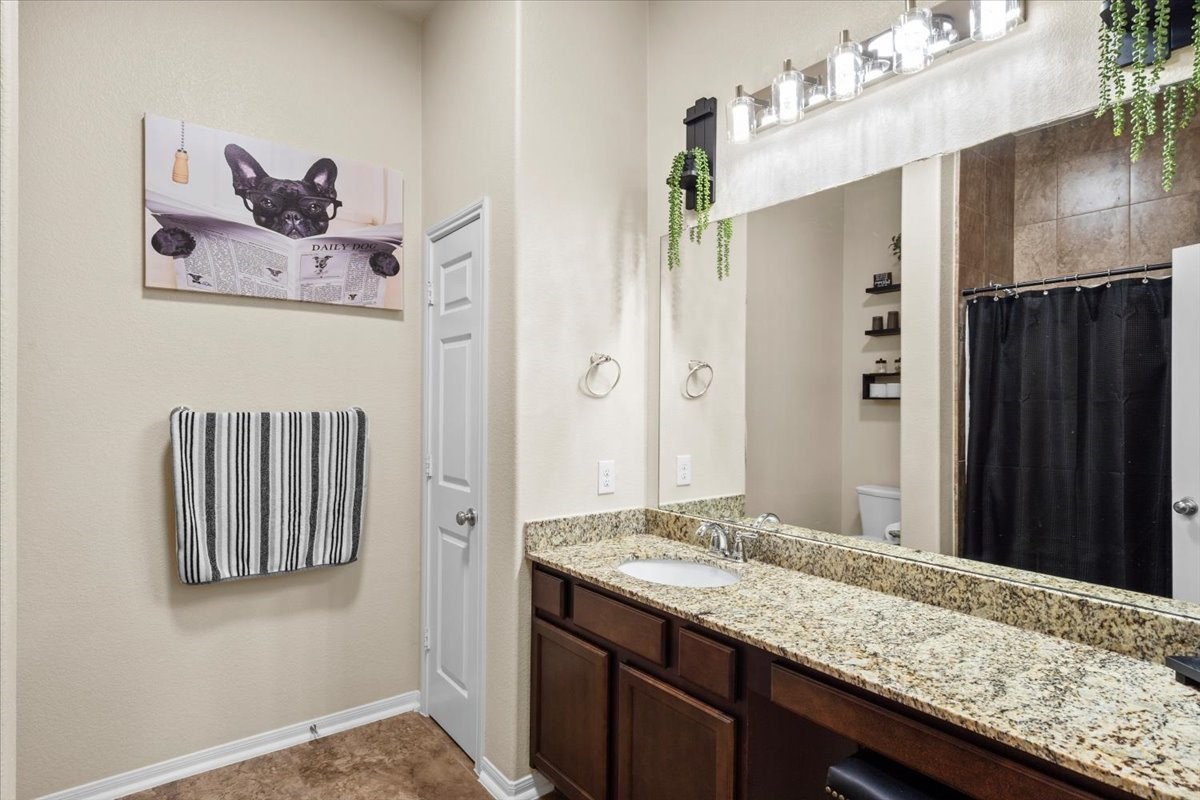 Secondary bath with granite-topped vanity and great lighting.