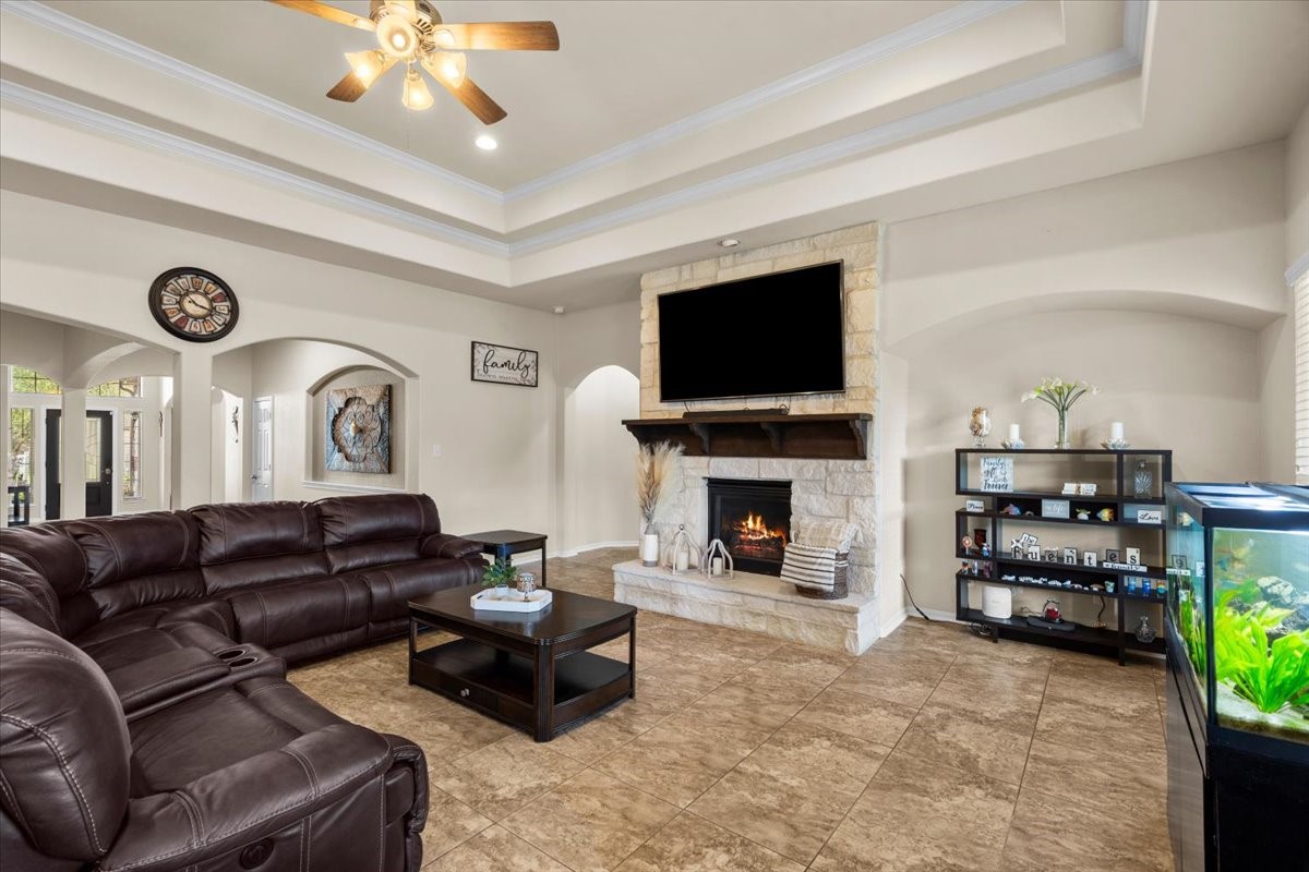 Open, light-filled family room with ceiling fan and tons of space for seating.