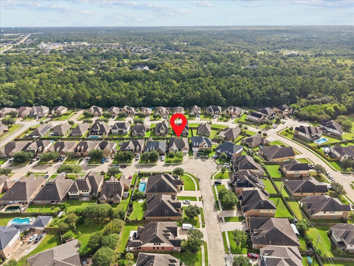 Aerial view showing the neighborhood and surrounding greenery.