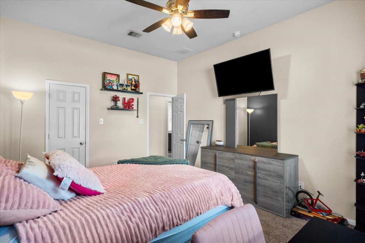 Spacious secondary bedroom with ceiling fan.
