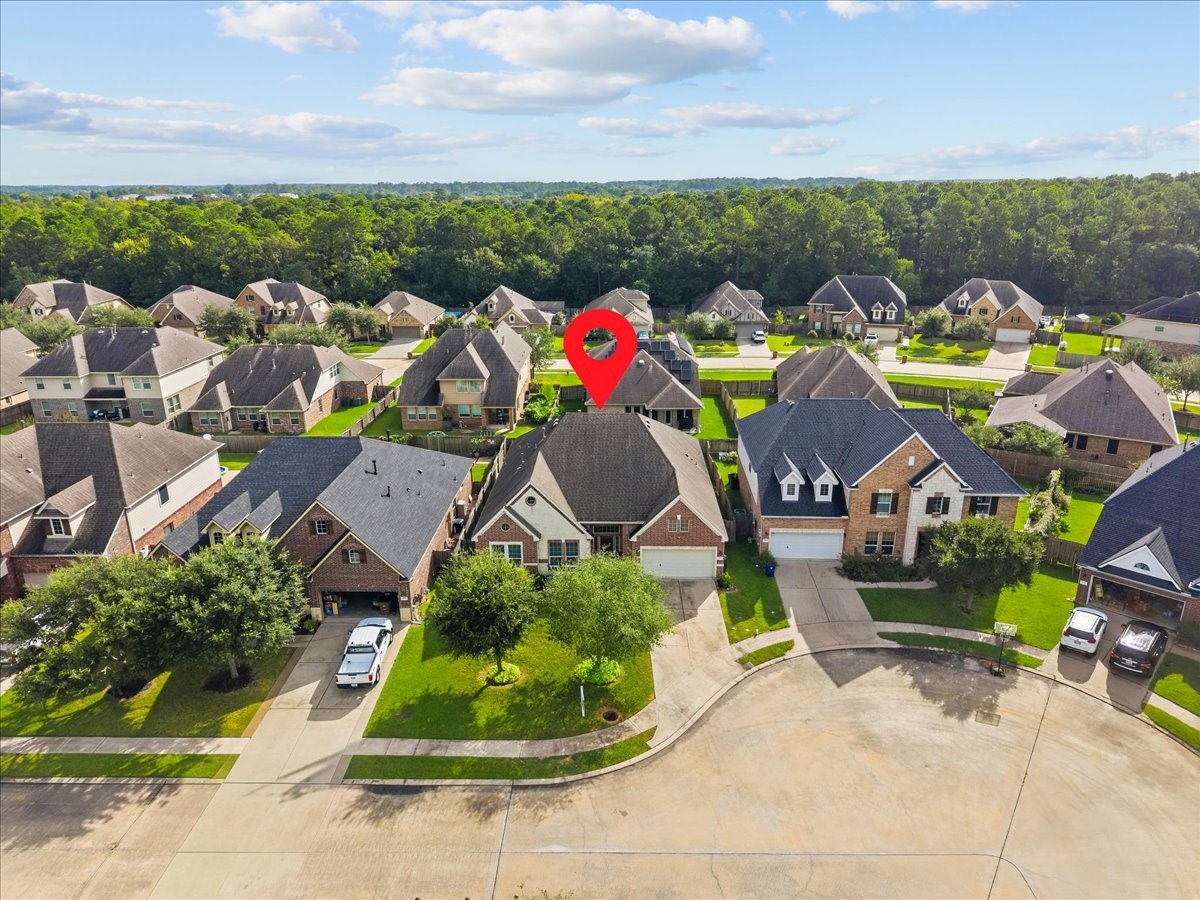 Aerial view of the home within the neighborhood.
