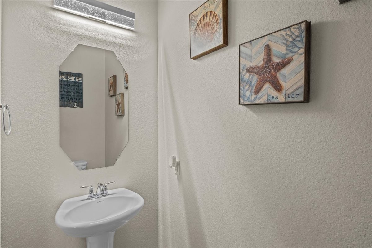 Guest bath with pedestal sink.