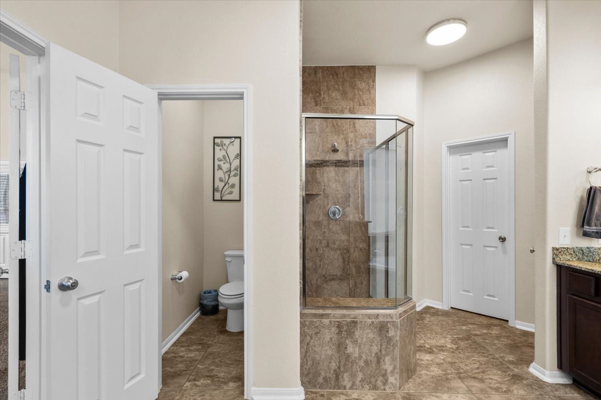 Separate glass-enclosed shower in the primary bath.