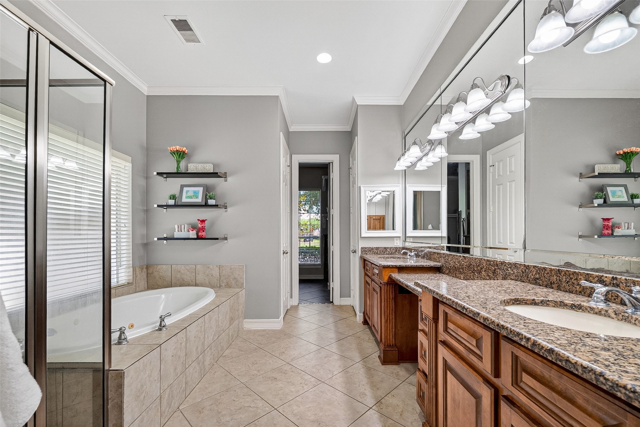 Double sinks with granite tops and beautiful wooden cabinetry.